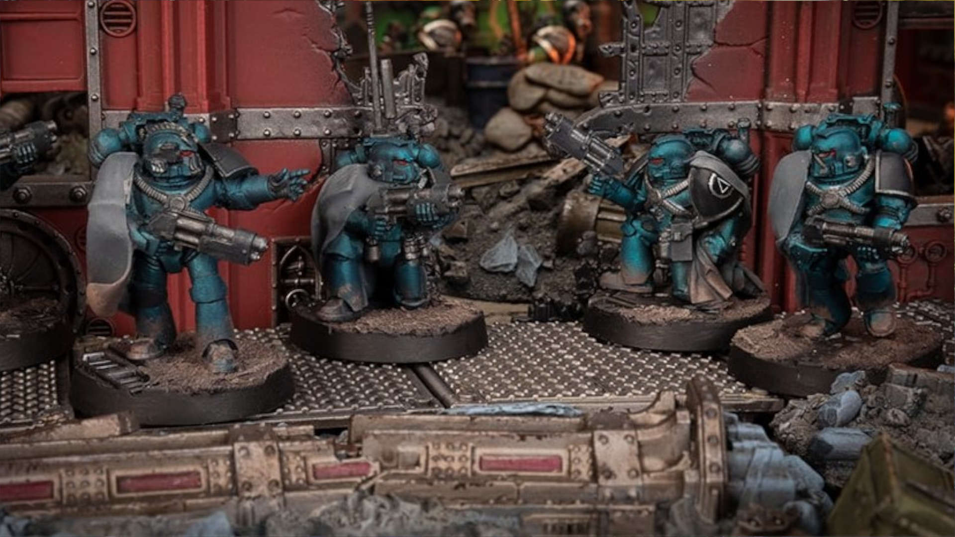 Alpha Legion legionaries in teal Mk IV plate advancing through a ruined industrial street