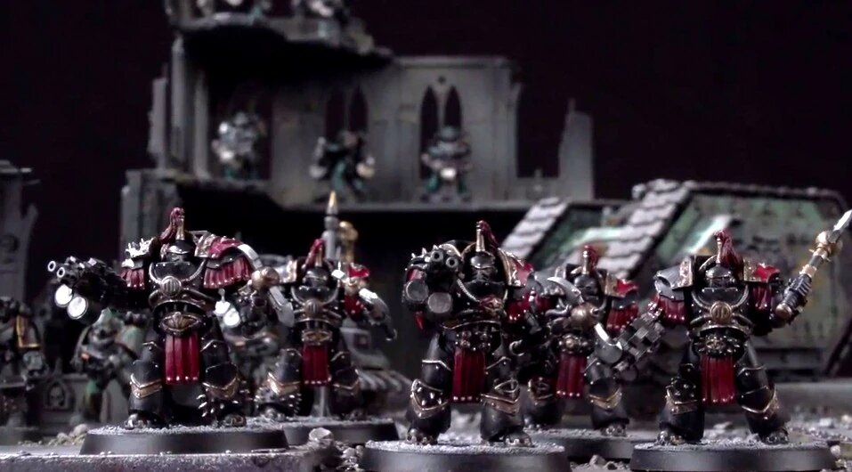 Justaerin Terminators in black and red Cataphractii plate, an older generation of Chaos Terminator sculpt