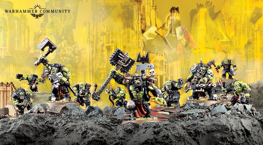 A mob of Goff Ork Boyz with shootas and choppas, led by a Nob with a power klaw