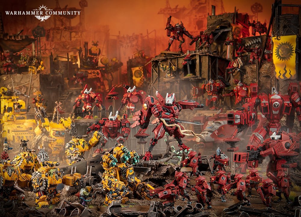 Farsight leading a red-armoured Enclave force of Crisis, Broadside and Riptide battlesuits against Orks
