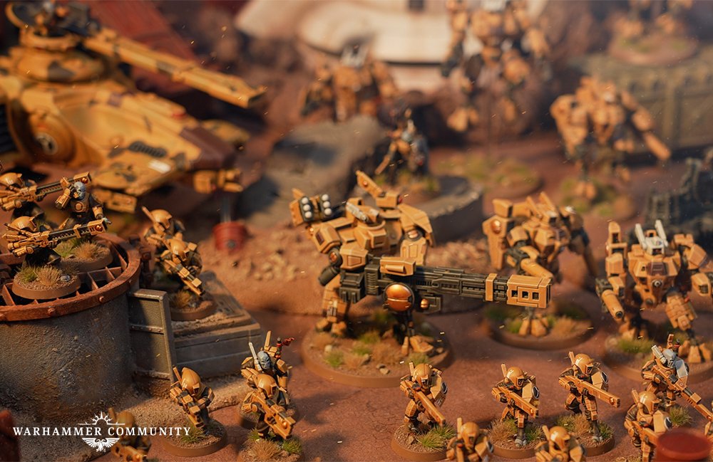 T'au battle force advancing in a desert war zone