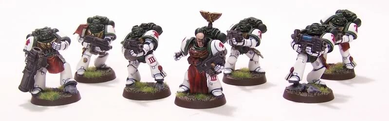 Mentors Tutor squad miniatures in the chapter's dark green and white scheme