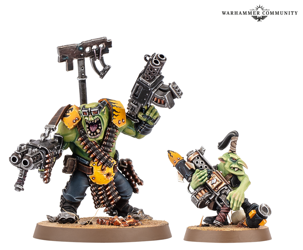 An Ork Nob draped in ammunition belts carrying twin kombi-weapons, alongside a Grot lugging a spare rokkit and drum magazine
