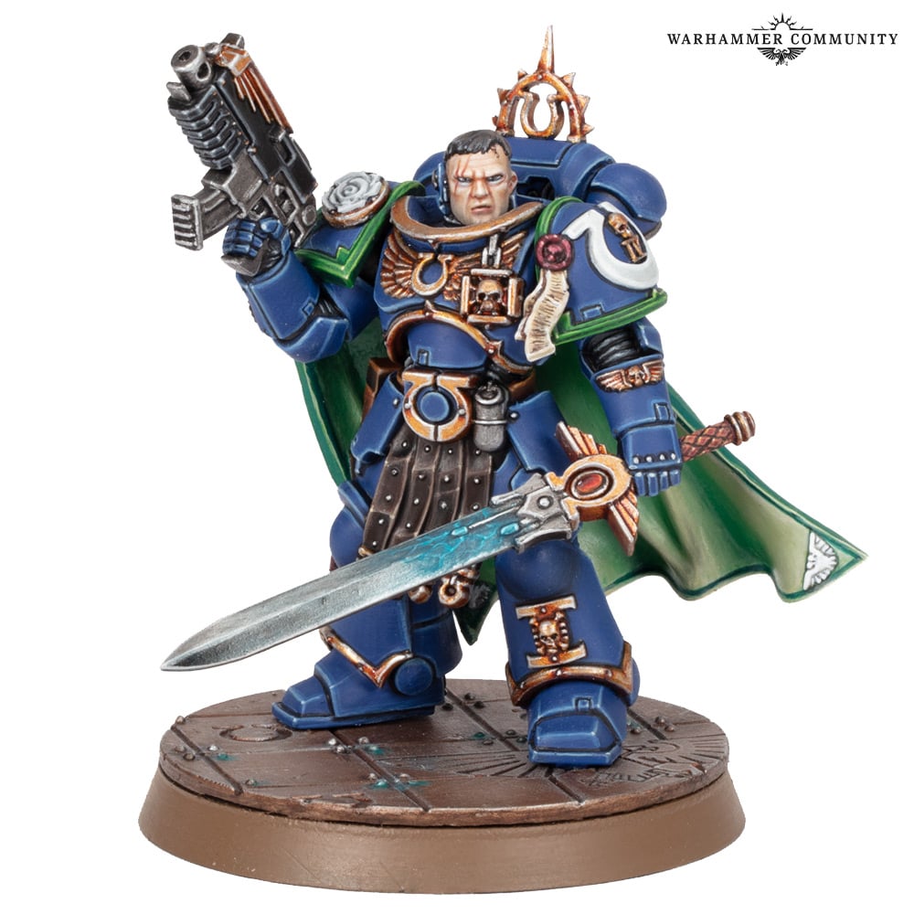 A blue-armoured Uriel Ventris miniature with green cloak, holding a power sword and bolt pistol