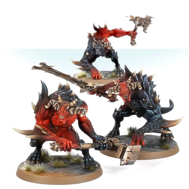 Three Ruinstorm Daemon Brutes, red and black horned daemons with axes and hammers, the generic unnamed daemon models of the Horus Heresy range