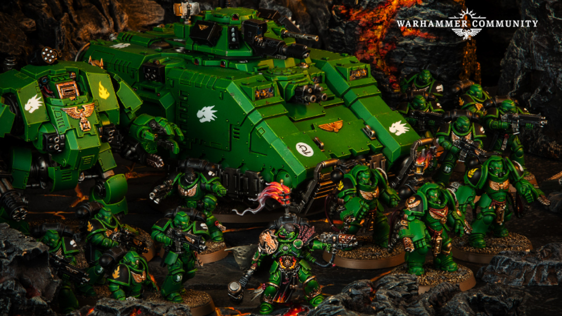 A Salamanders strike force with Redemptor Dreadnought and Repulsor advancing across volcanic rock